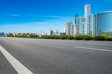 Empty asphalt road along modern commercial buildings in China's cities