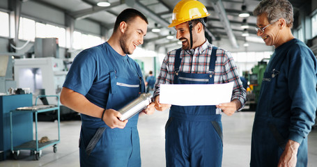 Team Of Engineers Having Discussion In Factory