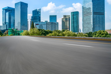 Empty asphalt road along modern commercial buildings in China's cities