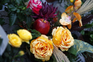 Red Apple in a bouquet of yellow roses