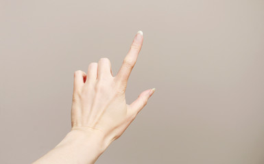 Woman's hand isolated on grey background.