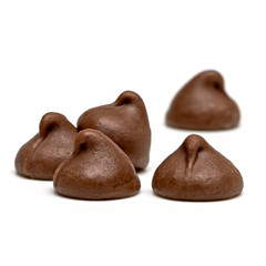 Chocolate drops  or chocolate chips morsels close up view isolated on white background