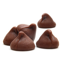 Chocolate drops or chocolate chips morsels close up view isolated on white background