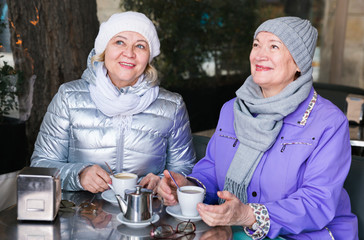 Fototapeta na wymiar Happy senior ladies in outdoors cafe