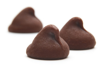 Chocolate drops  or chocolate chips from top view isolated on white background