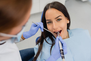 Dentist working on girls teeth