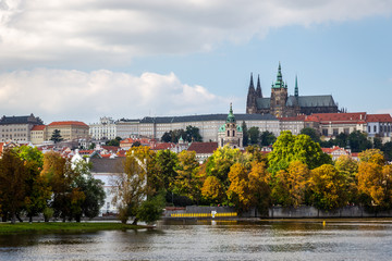 Beautiful colorful autumn cityscape view of Prague castle seen from the river.