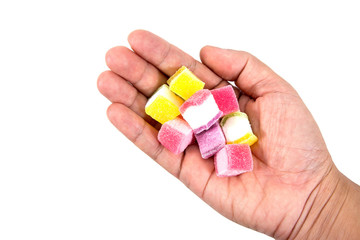 Colorful jelly candies in hand isolated on white background. Jelly candies with hand isolated