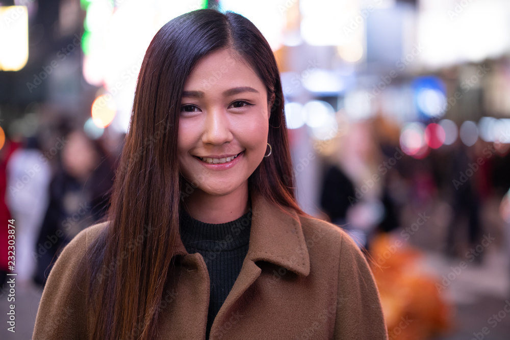 Canvas Prints Young Asian woman in city at night