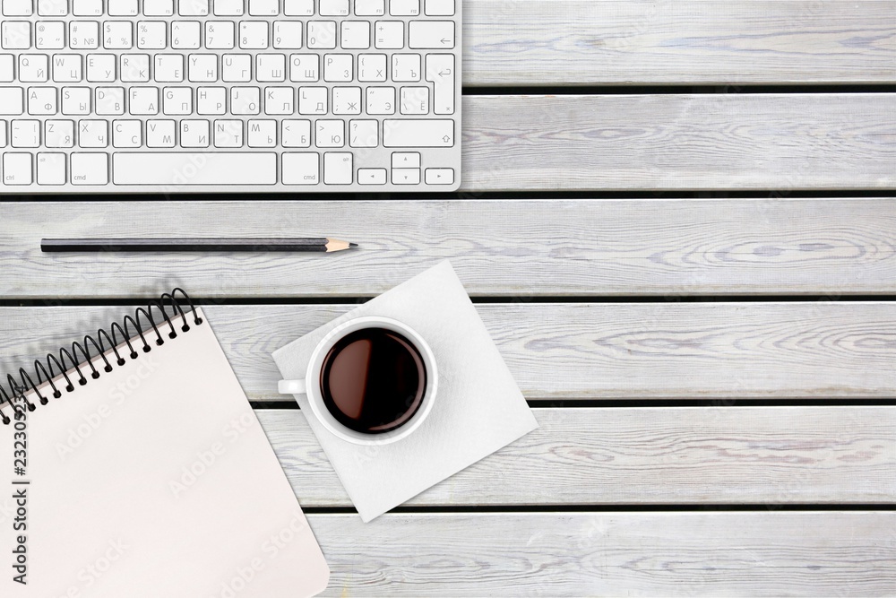 Poster computer keyboard at workplace and cup isolated on background