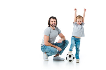 happy father and excited son playing football isolated on white