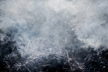 The texture of dense gray smoke from burning garbage_