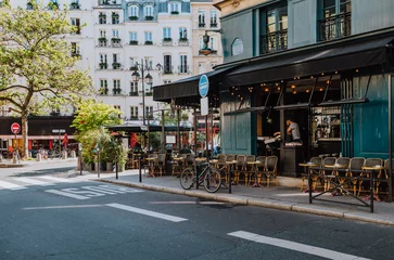 Poster Cozy street with tables of cafe  in Paris, France © Ekaterina Belova
