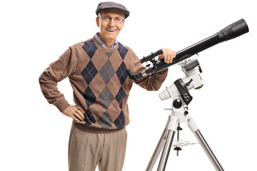 Smiling senior man with a telescope looking at the camera