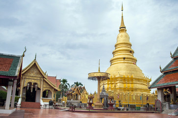 Naklejka premium Golden Pagoda at Phra That Hariphunchai Temple (Wat Phra That Hariphunchai) in Lamphun, north of Thailand