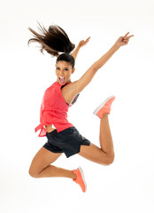 Attractive excited fitness modern dancer girl in sport wear jumping of joy dancing and working out