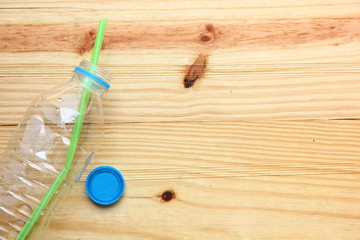 Fototapeta na wymiar plastic empty water bottle on wood floor background