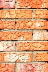 Wall of decorative bricks. Abstract background, texture. Vertical photo.