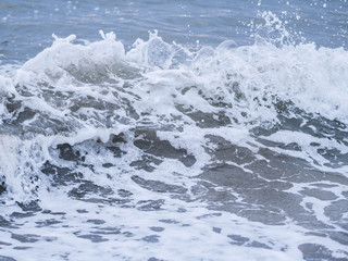 Waves at the seashore. Selective focus with shallow depth of field.