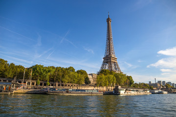 Fototapeta na wymiar PARIS, FRANCE, SEPTEMBER 8, 2018 - The Eiffel Tower from the river Seine in a sunny day in Paris, France