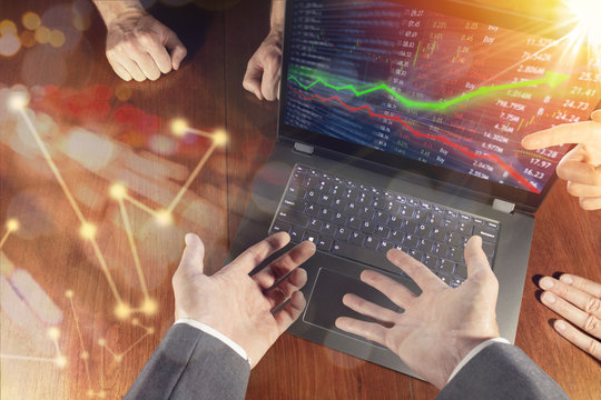 Stock market investment concept gain and profits with candlestick charts and numbers while financial business team debates and meets to discuss.