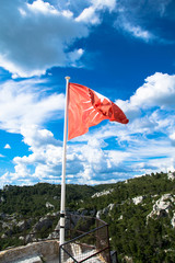 The red flag of the medieval village of Les-Baux-de-Provence in the Alpilles regional park, France