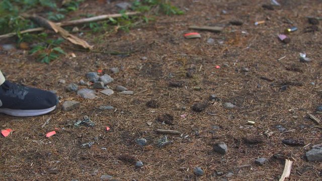 Shell Casings Falling onto the Ground as a Man Fires a Pistol