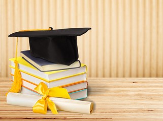 Graduation mortarboard on top of stack of books