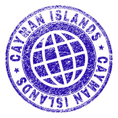 CAYMAN ISLANDS stamp imprint with grunge texture. Blue vector rubber seal imprint of CAYMAN ISLANDS tag with corroded texture. Seal has words placed by circle and planet symbol.