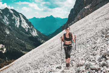 Young woman hiking on steep mountain slope