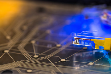 Yellow internet switch, plastic circuit board, glowing optical fibres on laptop keyboard abstract...