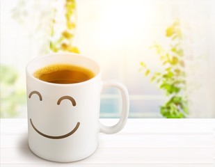 Black coffee in white cup with smiley