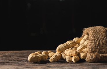 Pile of peanuts, peanuts stack on wooden table with copy space.