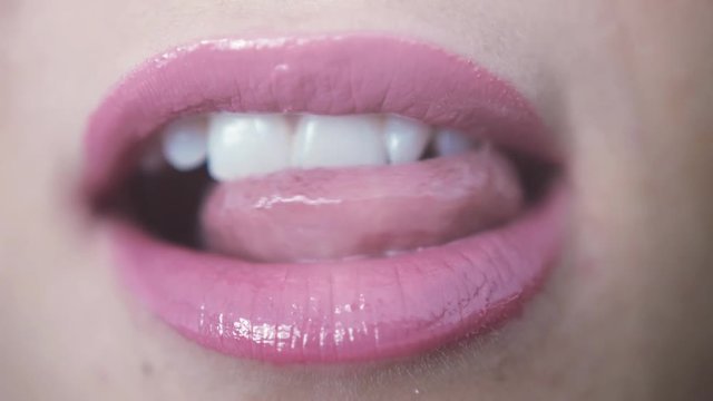Close up beautiful pink lips lick of young girl. 3840x2160