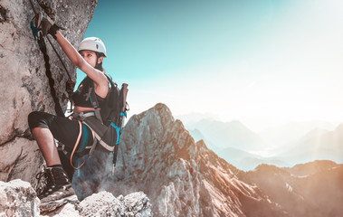 Young woman climbing in the alps