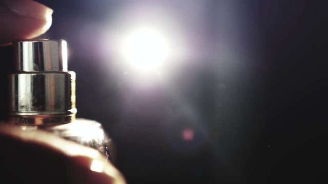 Spray bottle drops like perfume on a black background. slow motion. 1920x1080