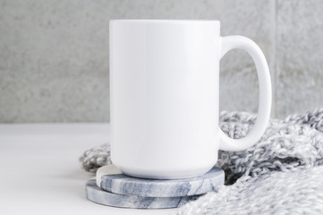 15 oz mug mockup with marble coasters and a grey blanket