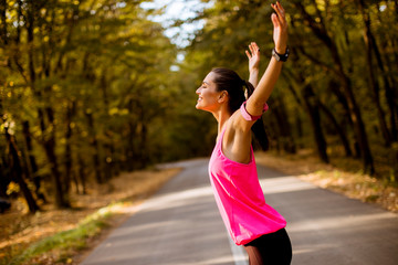 Female runner during outdoor workout in beautiful mountain nature landscape