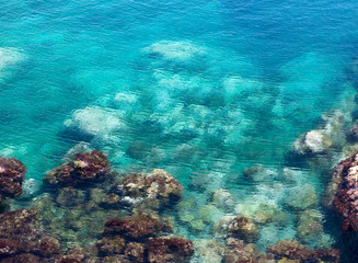 Fototapeta na wymiar Crystal emerald turquoise sea water , shoreline in Marsaskala, Malta