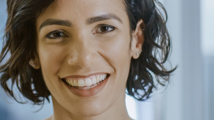 Portrait of a Beautiful Hispanic Woman Smiling Charmingly Stepping into Focus.