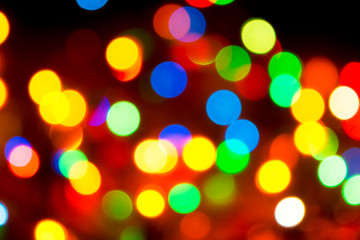 Christmas lights. Blurred festive background for a New Year's design. Winter holidays. Bokeh. Bright juicy colors.