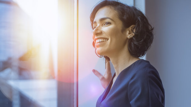 Close-up Portrait Of The Beautiful Young Hispanic Woman Looking Out Of The Window In Wonder. Summertime With Sun Flares In Frame.