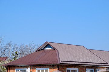 Fototapeta premium Metal roof brown. Construction of houses and types of roofing