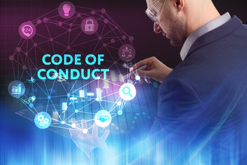 The concept of business, technology, the Internet and the network. A young entrepreneur working on a virtual screen of the future and sees the inscription: Code of conduct