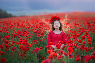 Amazing close up portrait of lovely cute young romantic girl with poppy flower in hand posing on...