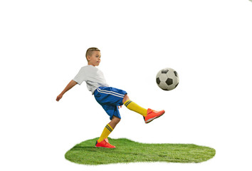 Young boy with soccer ball doing flying kick