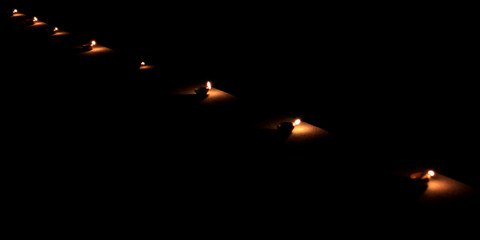 Earthen diya lamp lighting with candles on the occasion of diwali and sandhi pujo.
