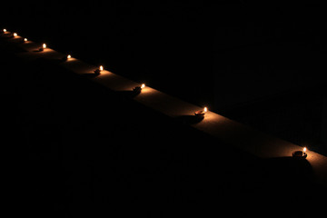 Earthen diya lamp lighting with candles on the occasion of diwali and sandhi pujo.