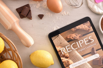 Using digital cookbook app in tablet in pastry - obrazy, fototapety, plakaty