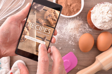 Using digital recipes app in mobile in pastry - obrazy, fototapety, plakaty